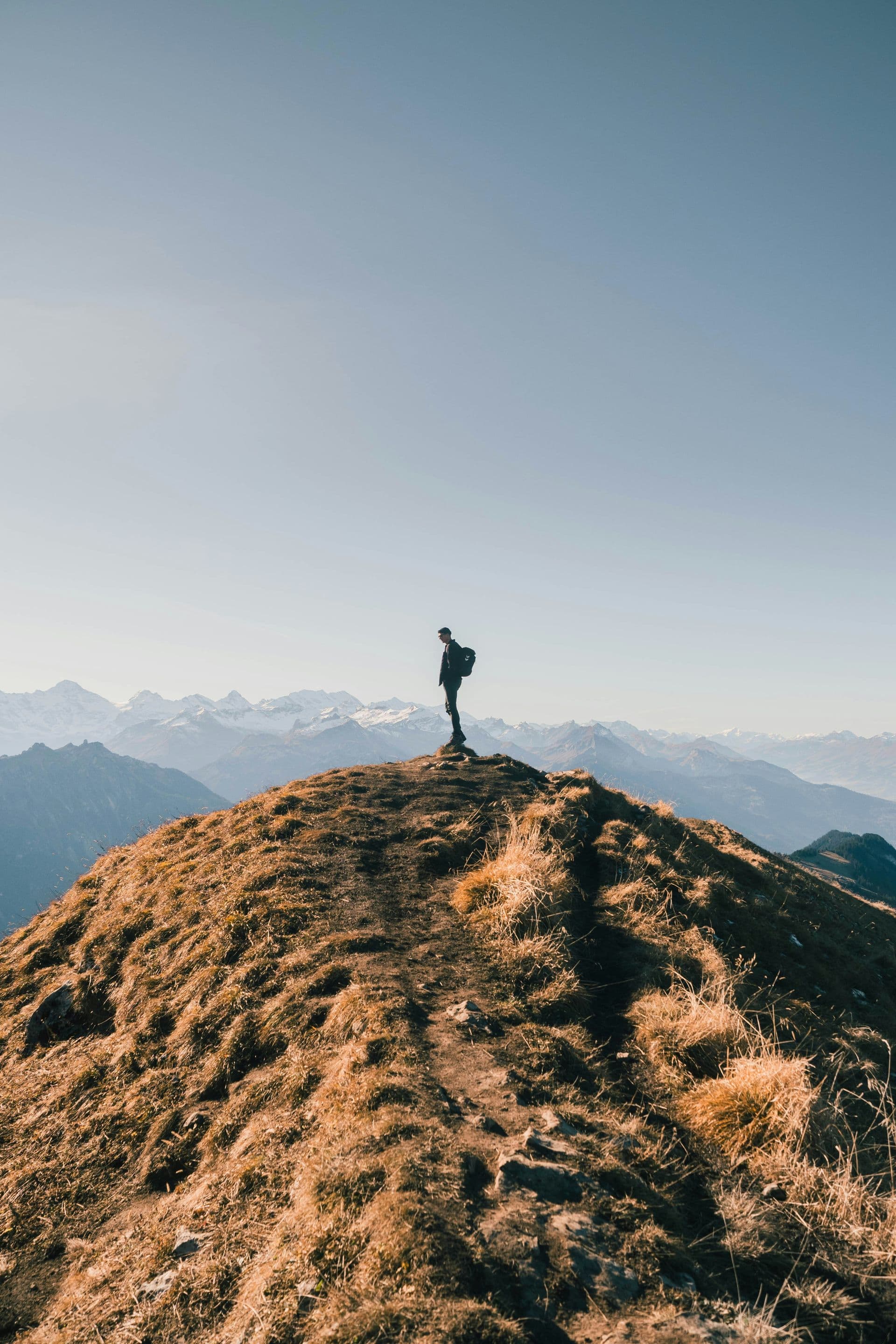 Person standing on mountain summit